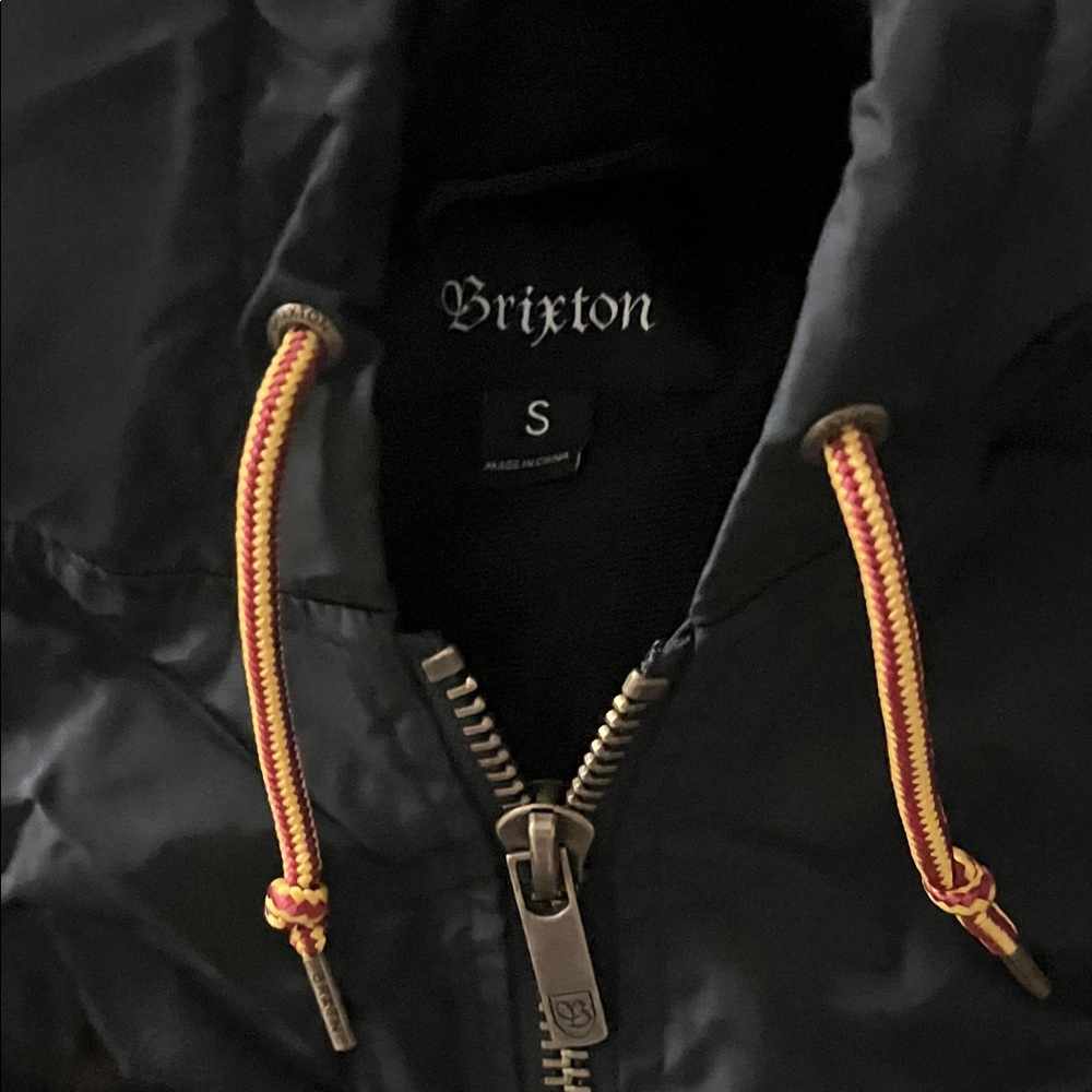 Brixton Men's Black Hooded Puffer with Yellow and Red Drawcords for the sunsets.